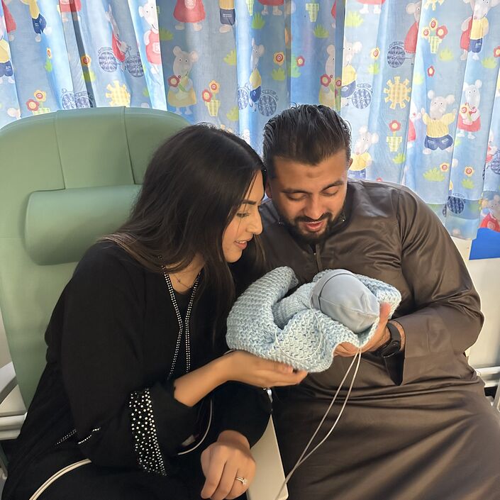 Farhaa and Wasim holding Riyadh