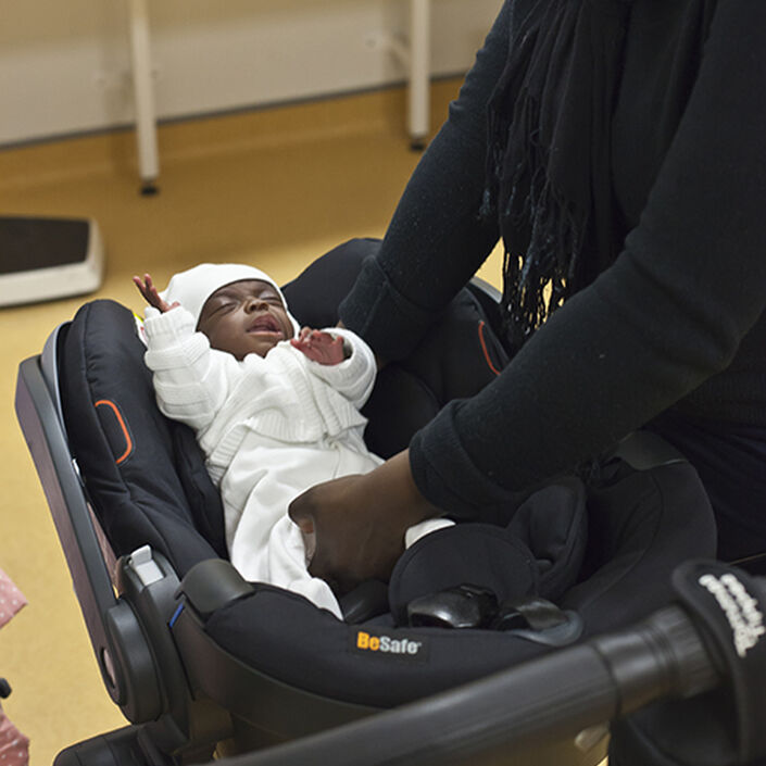 Baby being placed in car seat