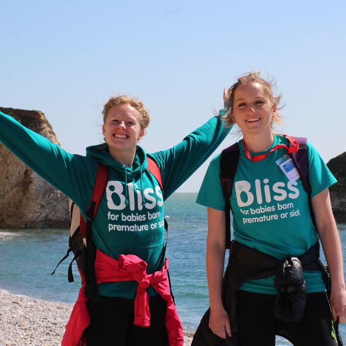 Two women in Bliss top, standing on a beach and smiling