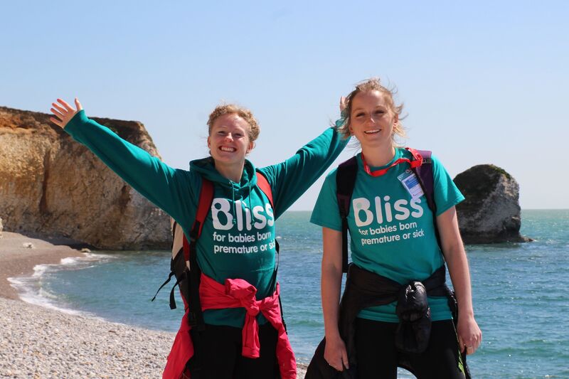Two women in Bliss top, standing on a beach and smiling