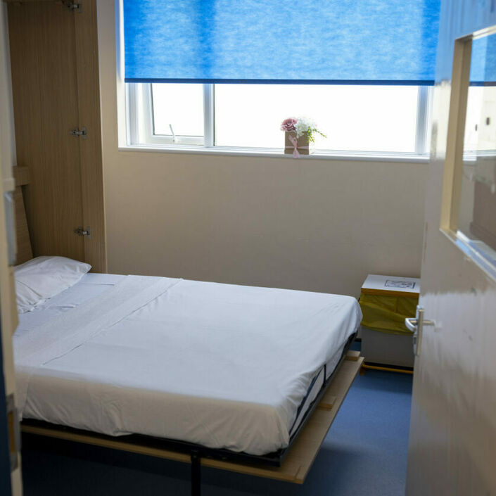 A small room with a fold-down bed.