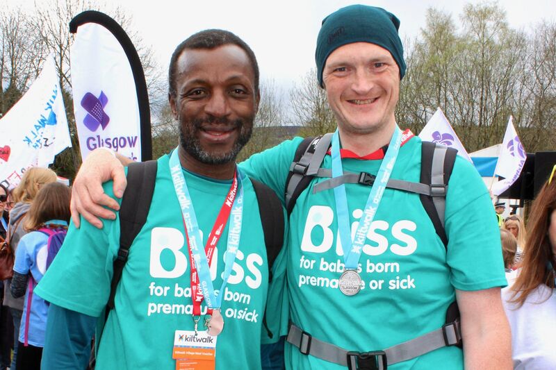 Two men in Bliss t-shirts at the finish line of the Glasgow Kiltwalk