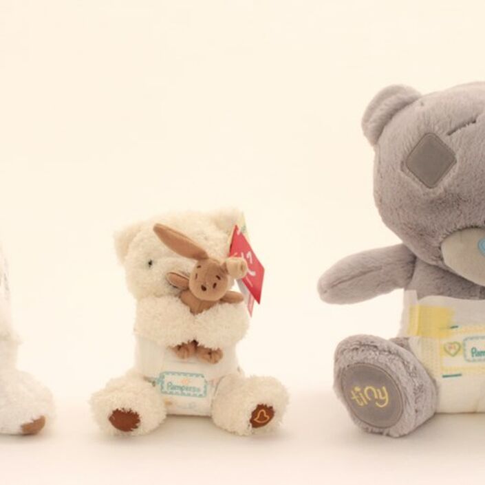 Three teddy bears placed together arranged in height order