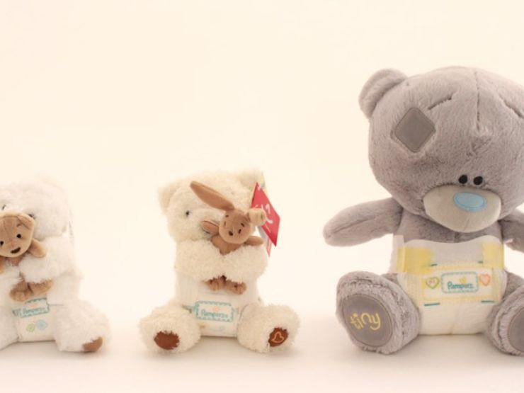 Three teddy bears placed together arranged in height order