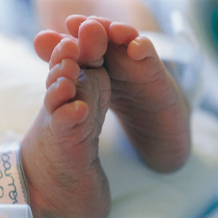 Premature baby's feet in a hospital setting