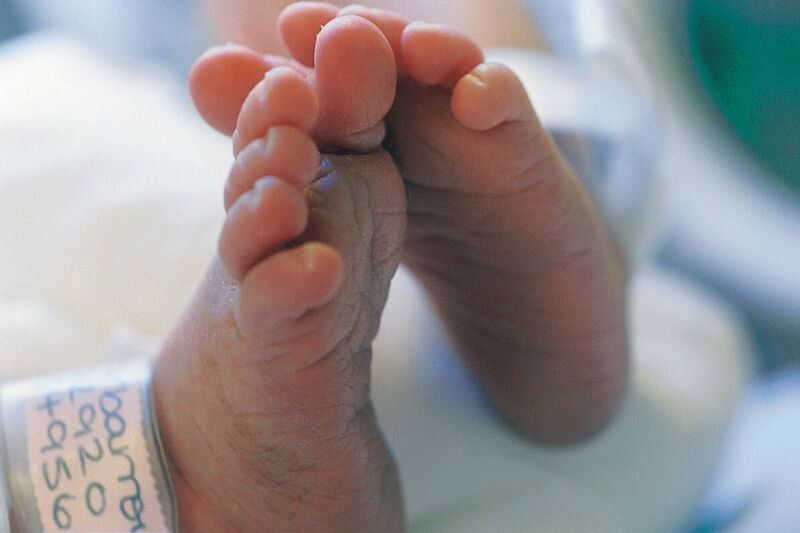 Premature baby's feet in a hospital setting