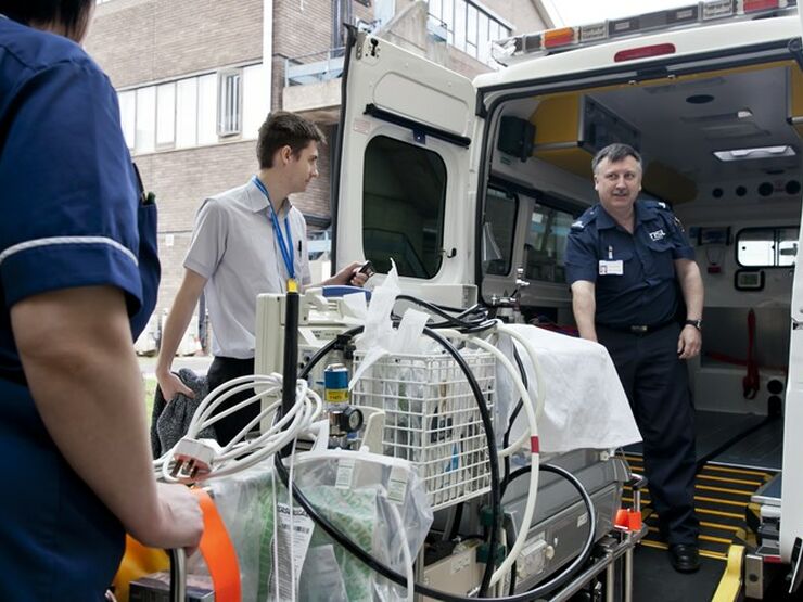 Specialist equipment being loaded into the back of an ambulance for transportation
