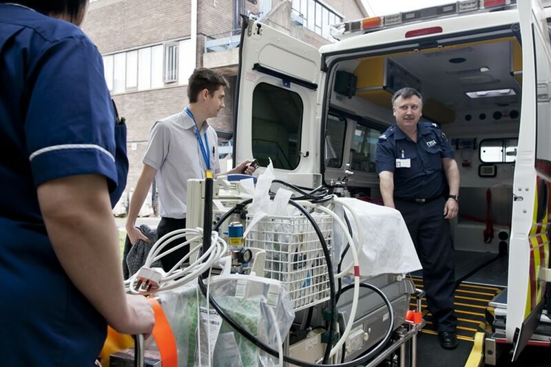 Specialist equipment being loaded into the back of an ambulance for transportation
