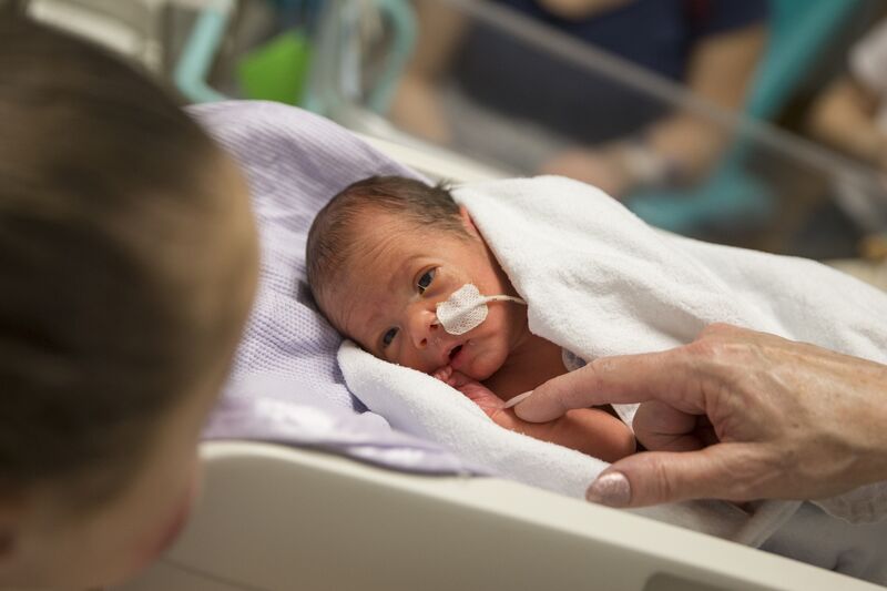 Baby in hospital looking at mum