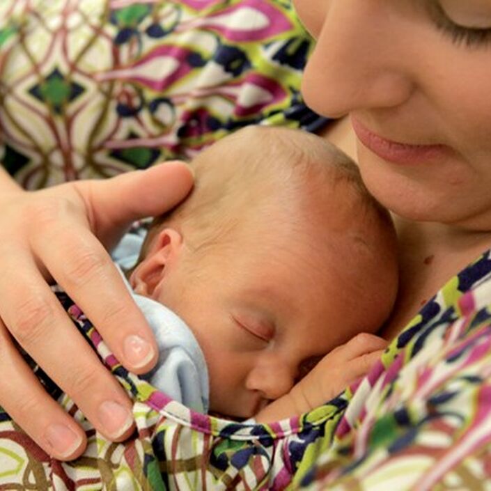 Mother holding her sleeping baby on her chest