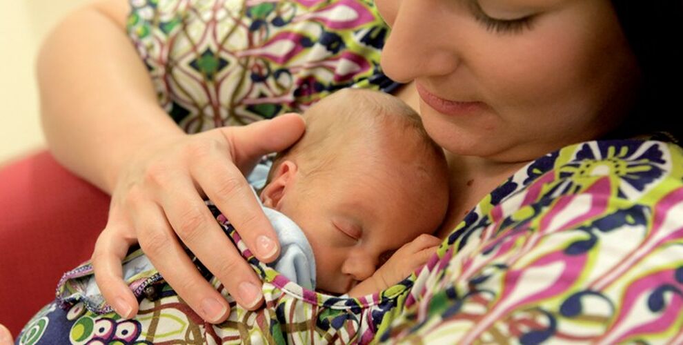 Mother holding her sleeping baby on her chest