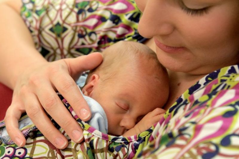 Mother holding her sleeping baby on her chest