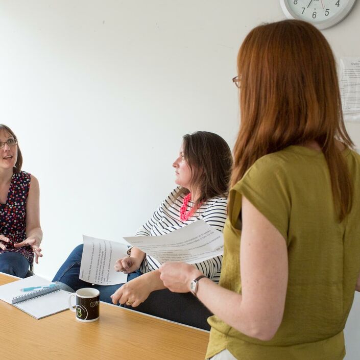 Members of research panel sat around a table talking