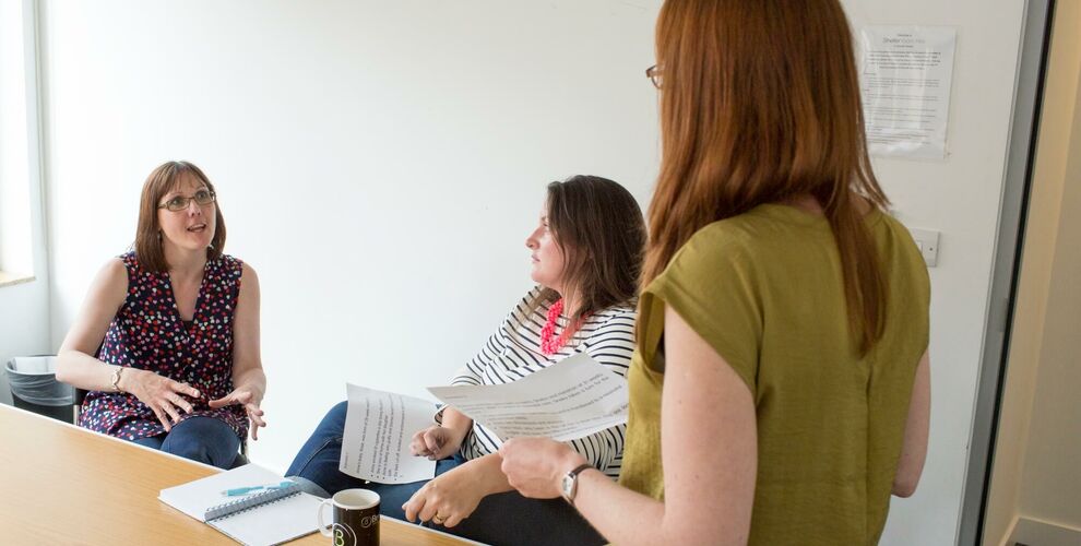 Members of research panel sat around a table talking