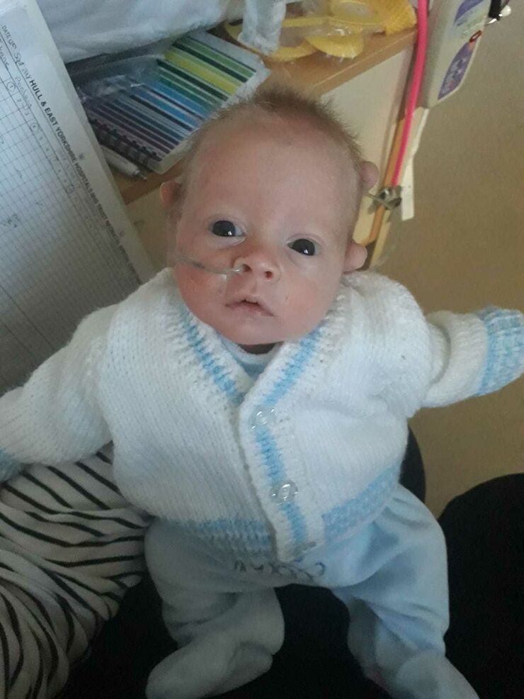 Baby Kane on his mother's lap in hospital