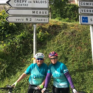 2 Bliss riders in france under a sign post