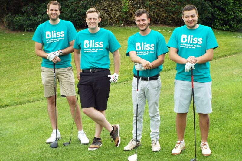 four men posing with Golf clubs wearing Bliss t-shirts