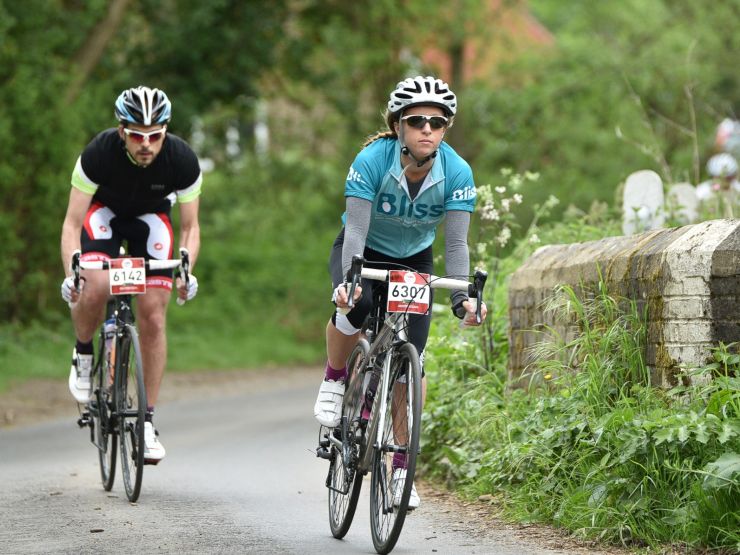 Two Bliss riders cycling on country lane