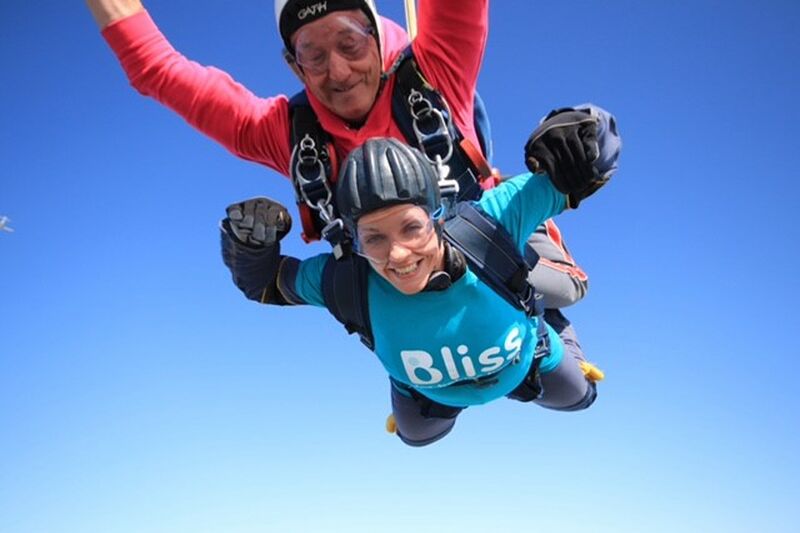 Bliss female fundraiser mid-air during a tandem skydive