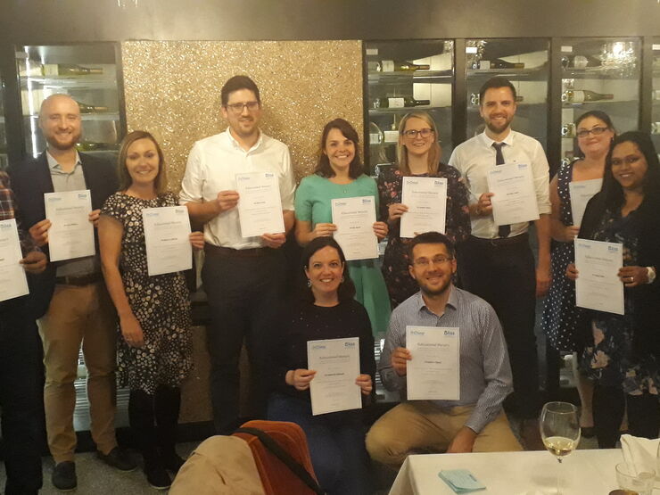 successful bursary applicants posing with their certificates