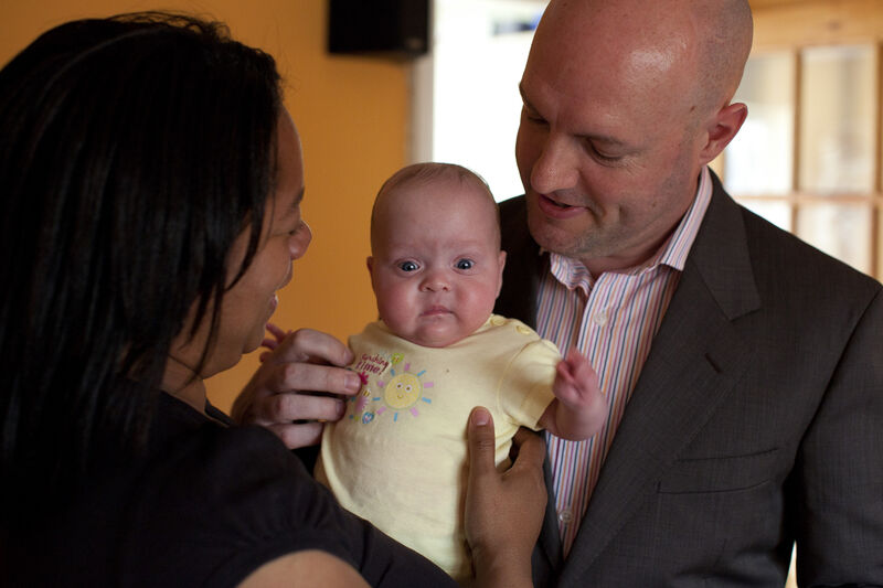 Mother and father holding their baby together