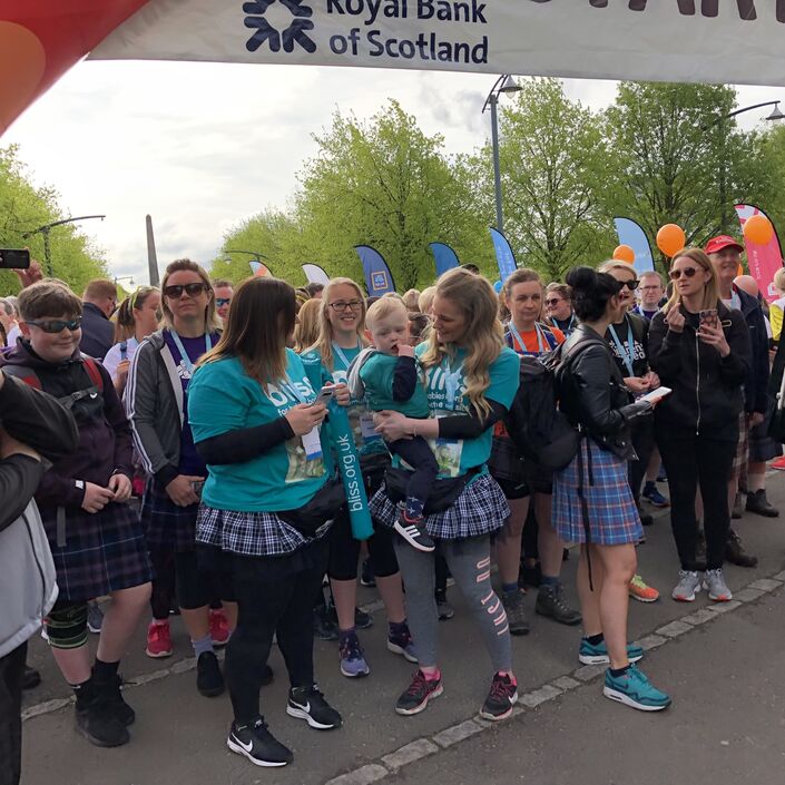 Bliss fundraisers wearing Bliss t-shirts standing at an event start line