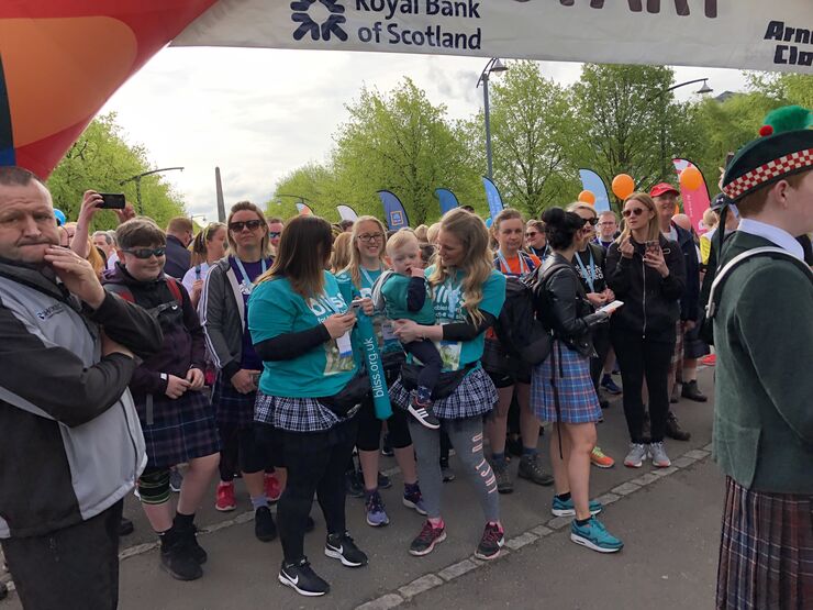 Bliss fundraisers wearing Bliss t-shirts standing at an event start line