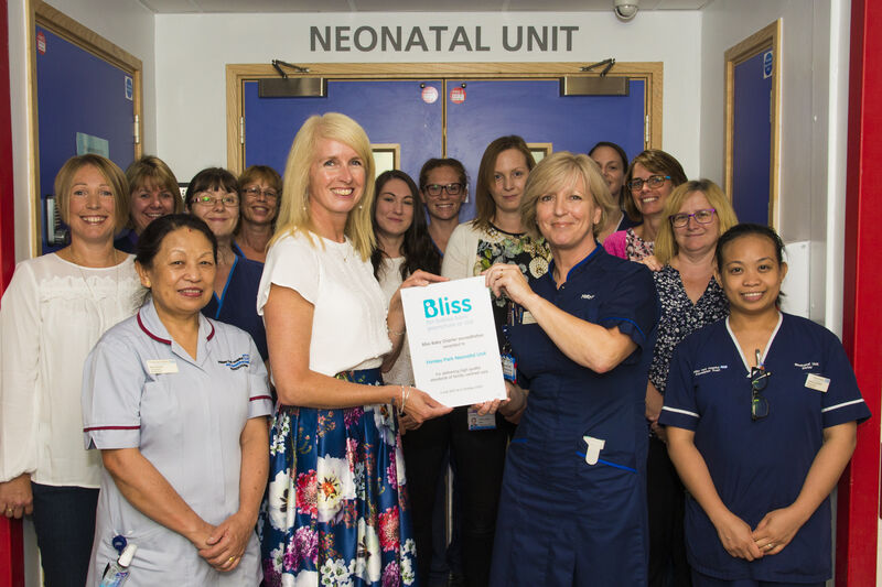 Staff at Frimley Park hospital posing while holding a Bliss accreditation plaque