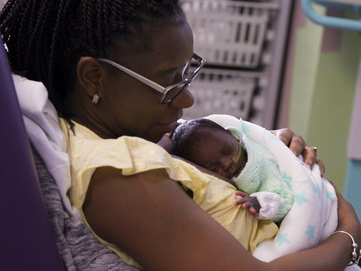 Woman holding her baby in a hospital