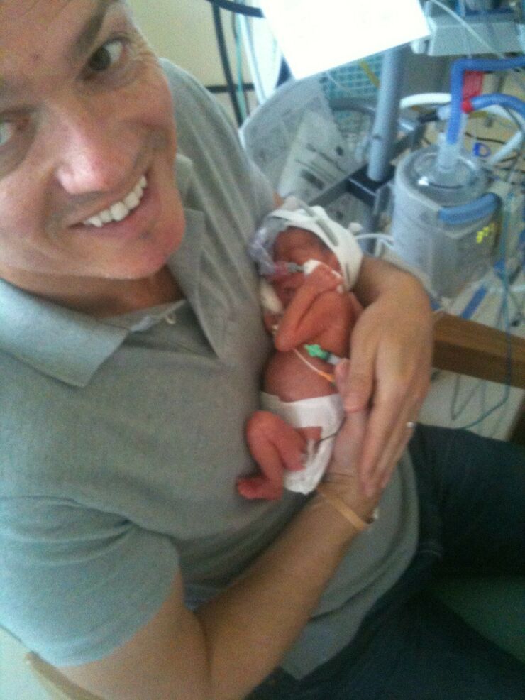 Jason holding one of the twins on the unit