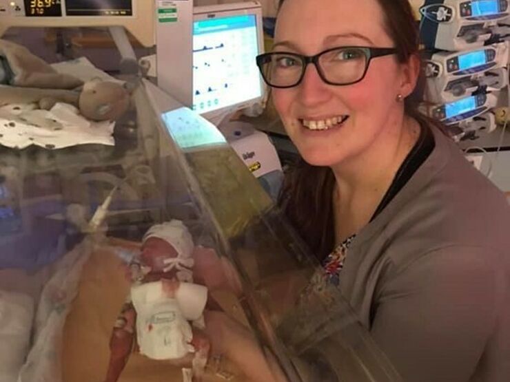 Jennie holding her son Rex, who is in an incubator in NICU