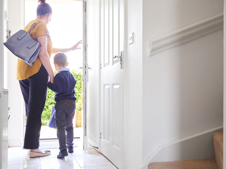 Mum and young child at the doorway leaving home for school