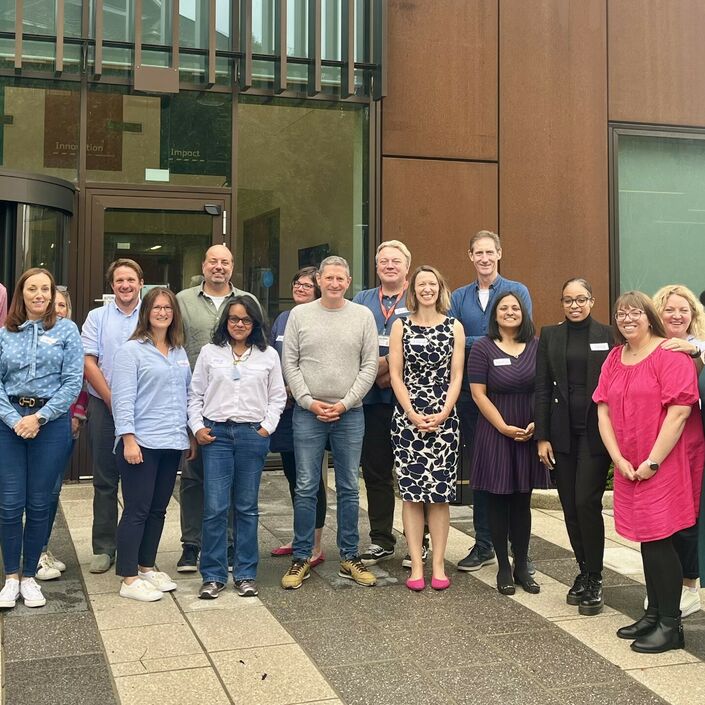 Trustees posing outside building