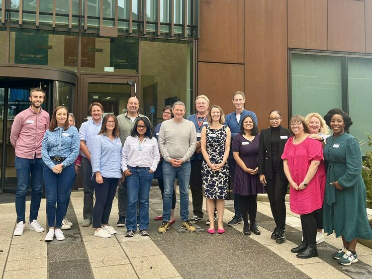 Trustees posing outside building