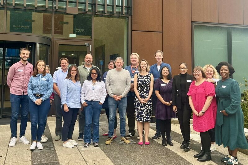 Trustees posing outside building