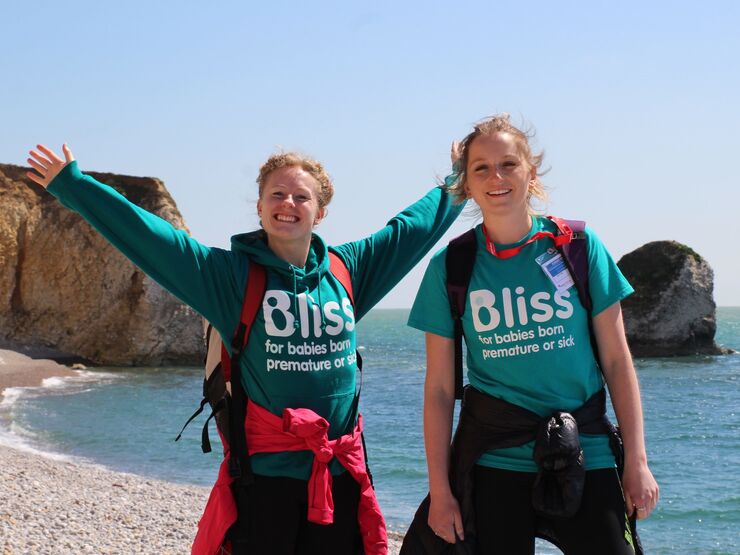 Two women in Bliss top, standing on a beach and smiling