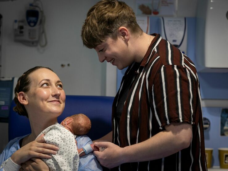 Two parents with their baby in hospital