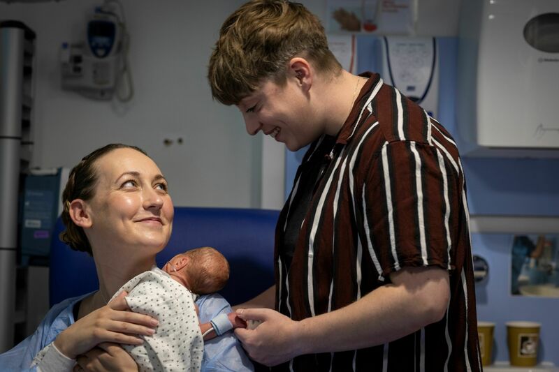 Two parents with their baby in hospital