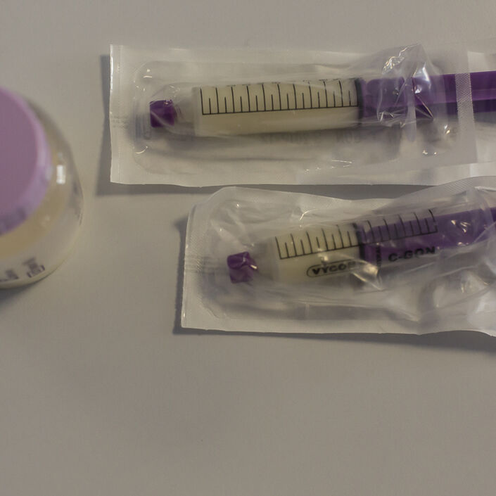 Bottle and two syringes with expressed milk