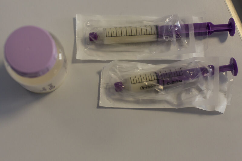 Bottle and two syringes with expressed milk