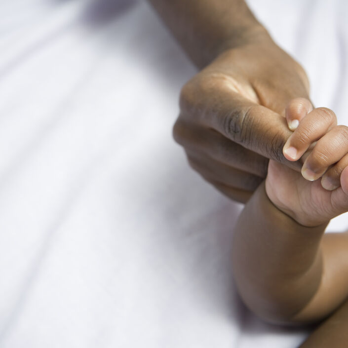 Parent and baby holding hands 182173182