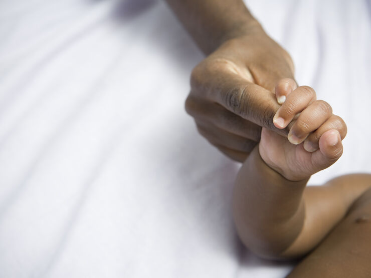 Parent and baby holding hands 182173182