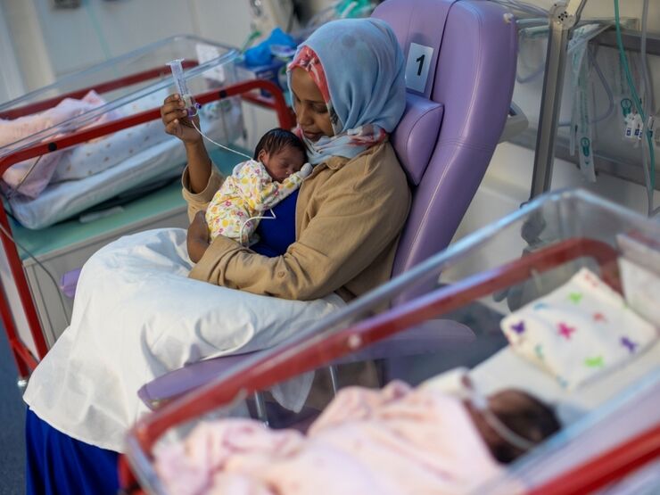 Woman holding her baby in a hospital setting