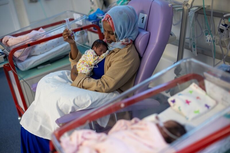 Woman holding her baby in a hospital setting