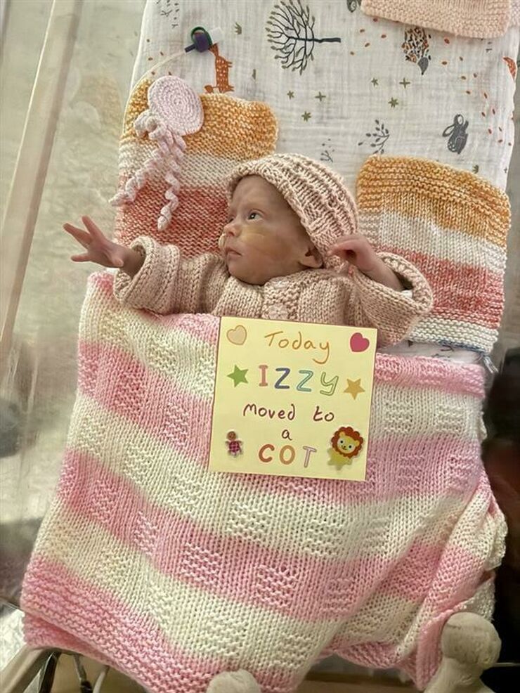 Izzy 7weeks into a cot