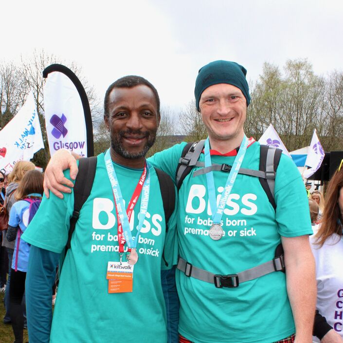 Two men in Bliss t-shirts at the finish line of the Glasgow Kiltwalk