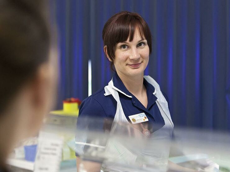 Nurse smiling in a neonatal hospital setting