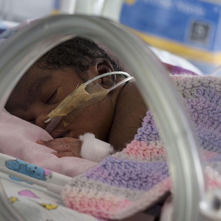 Baby in incubator asleep