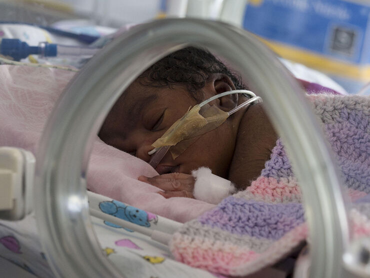 Baby in incubator asleep