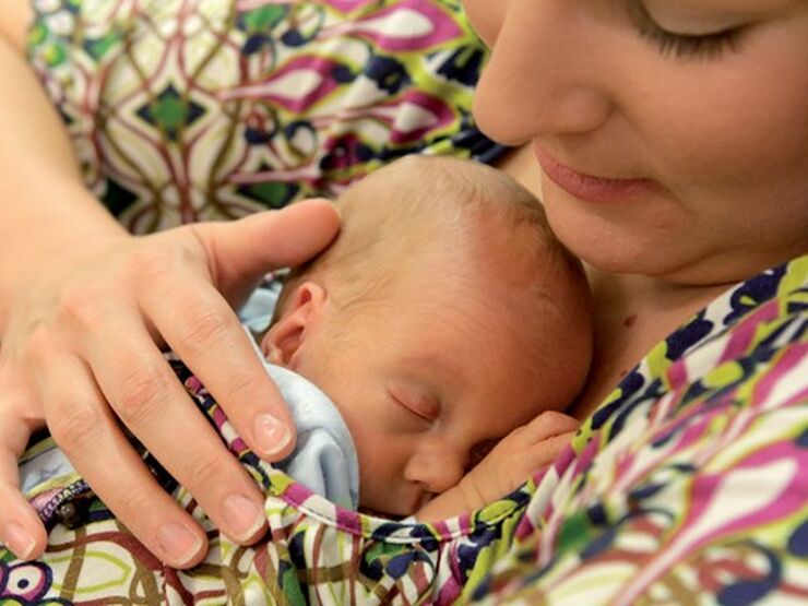 Mother holding her sleeping baby on her chest